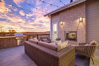 Sun deck with a fireplace and a grill at Connect at First Creek, Denver, Colorado